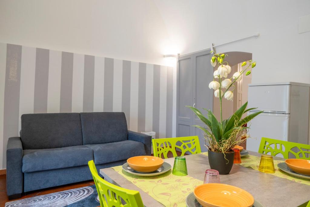 a living room with a table and a blue couch at Martini Holiday's house in Altamura