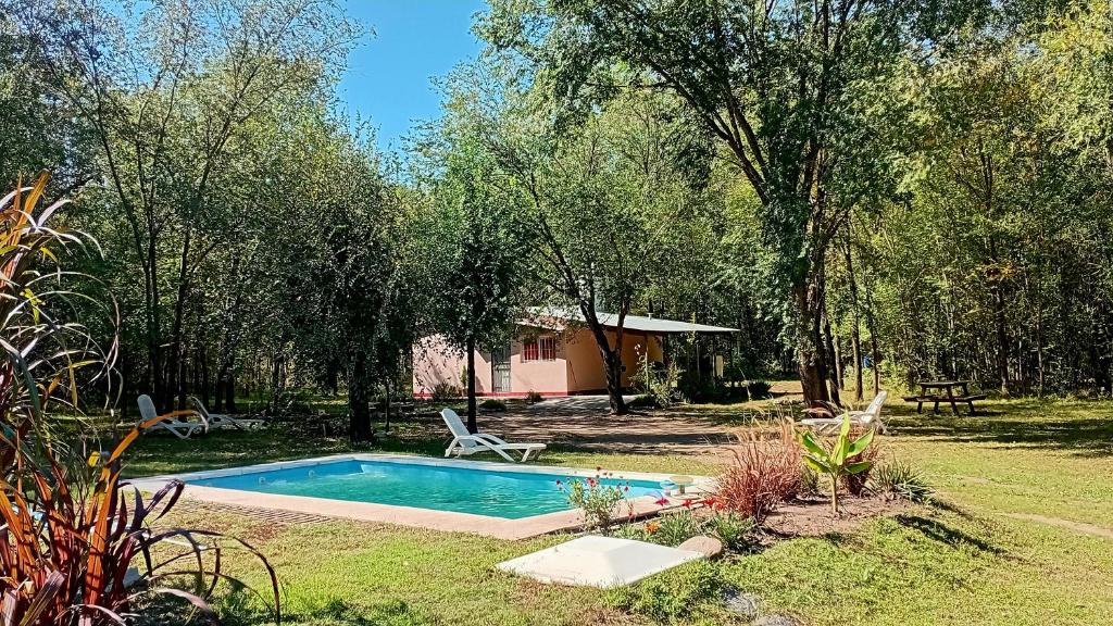 a swimming pool in the middle of a yard at La Casita del Vivero in Casa Grande