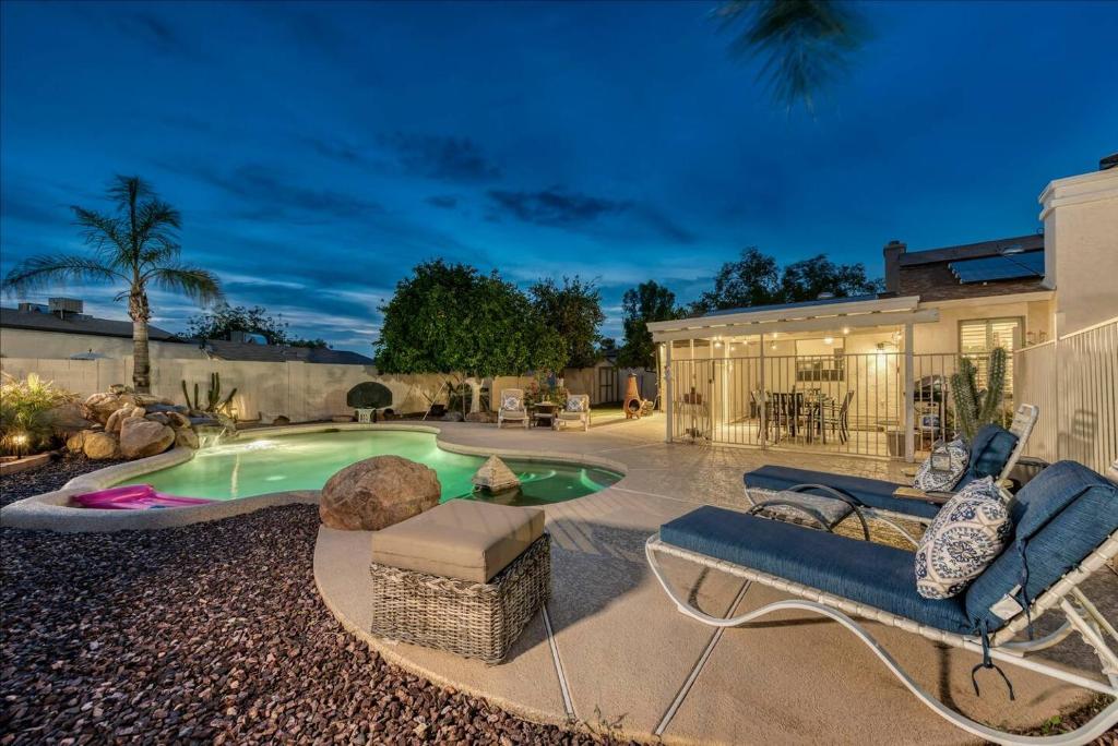 a backyard with a swimming pool with a bench and a house at Your Private Desert Getaway With Free Heated Pool! in Phoenix