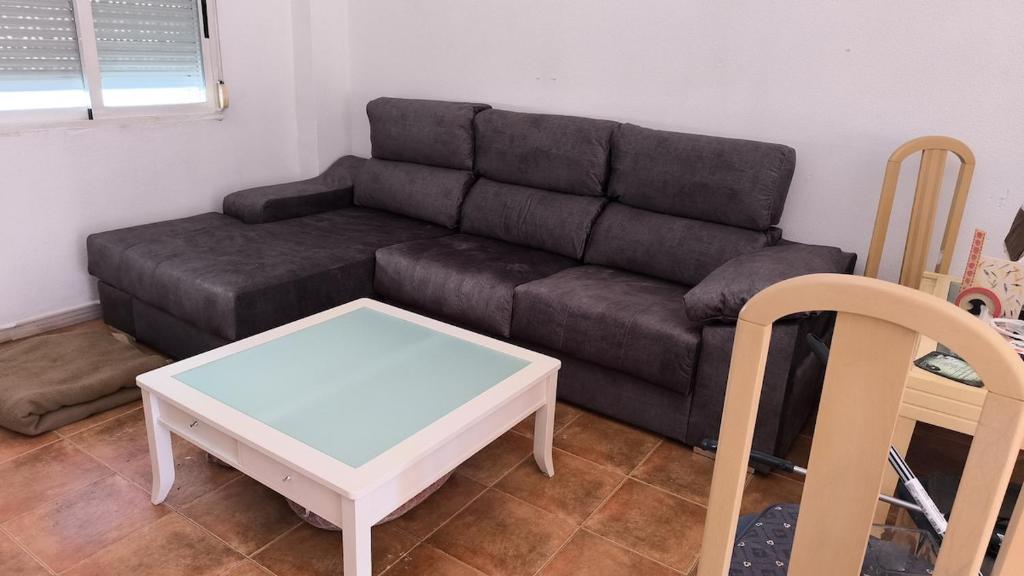 a living room with a couch and a coffee table at Townhouse with pool next to the City of Arts in Valencia