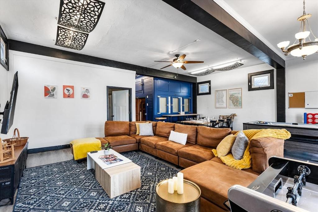 a living room with a couch and a table at Blue Storefront 2ksqft, Arcade,Pooltable,Foosball in Milwaukee