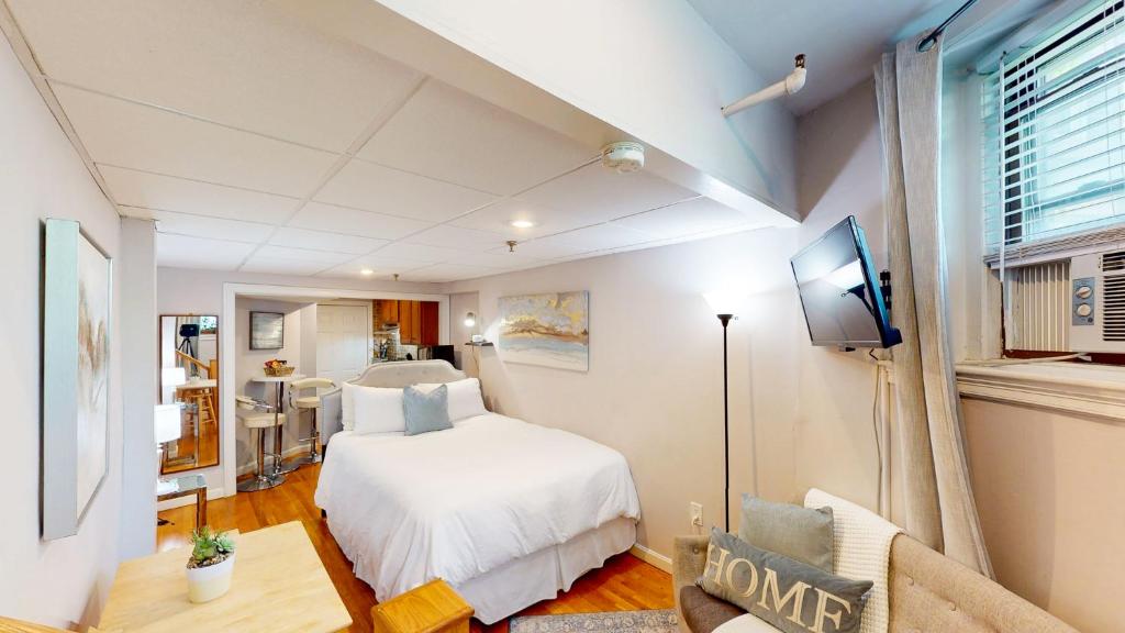 a bedroom with a bed and a tv in a room at Near Public Transport, Fenway, Bu, Longwood Med in Brookline