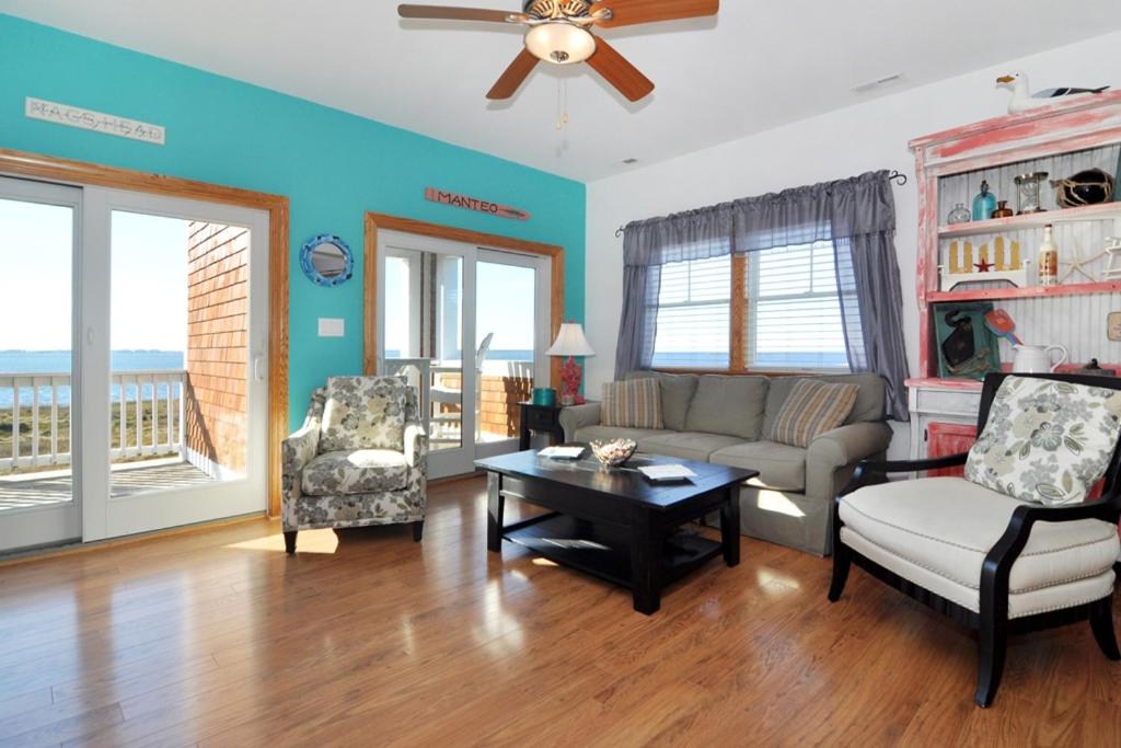 a living room with a couch and chairs and a table at Surround Sound in Nags Head
