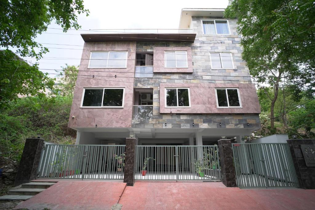 a house with a gate in front of it at Lakeside Bliss Homestay in Udaipur
