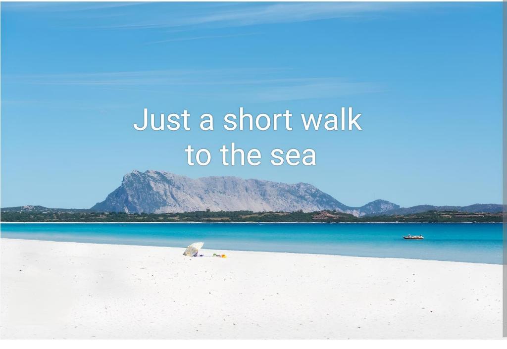 a picture of a beach with the words just a short walk to the sea at Casa vacanza tra il mare e il centro di San Teodoro in San Teodoro