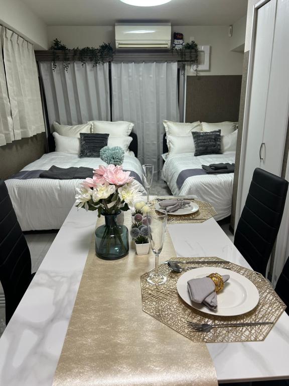 Postel nebo postele na pokoji v ubytování メルシアターリゾート3