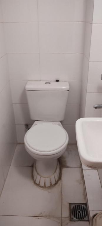 a white bathroom with a toilet and a sink at Alquilo Casa en Barrio Bombal in Barraquero