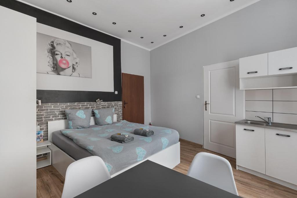 a bedroom with a bed and a kitchen at 70s Business Room in Krakow