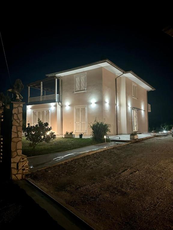 a large white house at night with lights at Luxury Villa Cenaia in Cenaia Vecchia