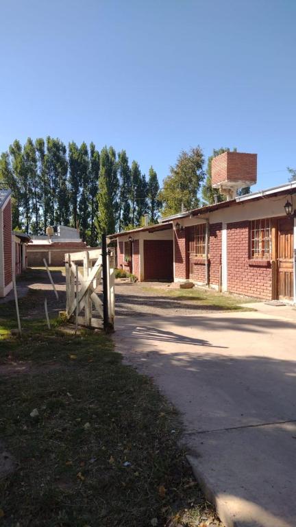 a house with a wooden gate and a fence at MARY ORM House 2 in Malargüe