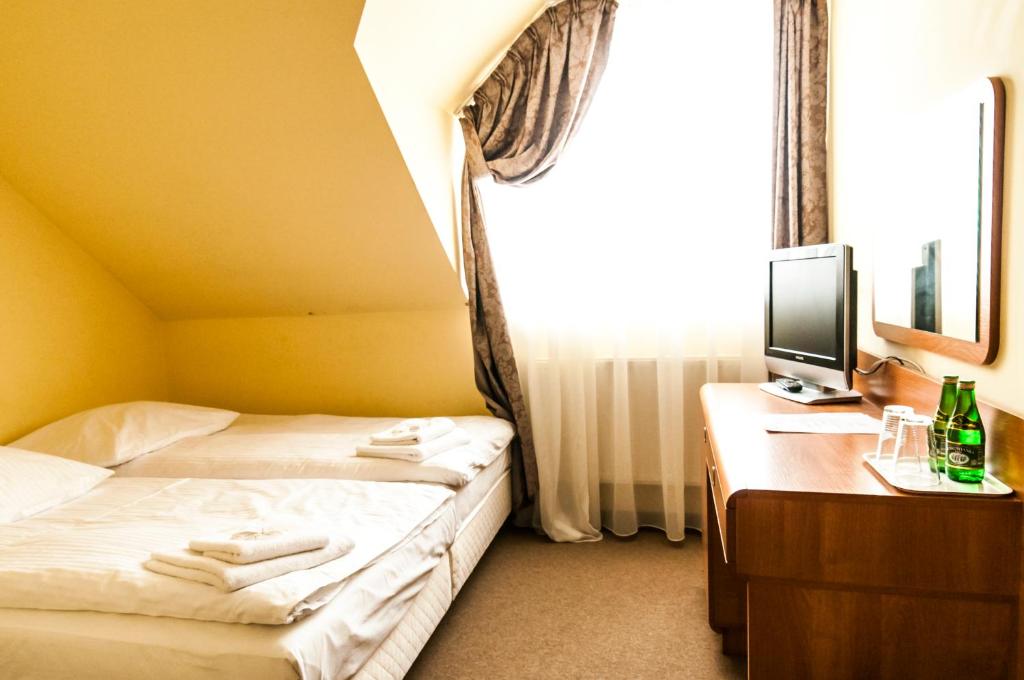Postel nebo postele na pokoji v ubytování Hotel Oleńka