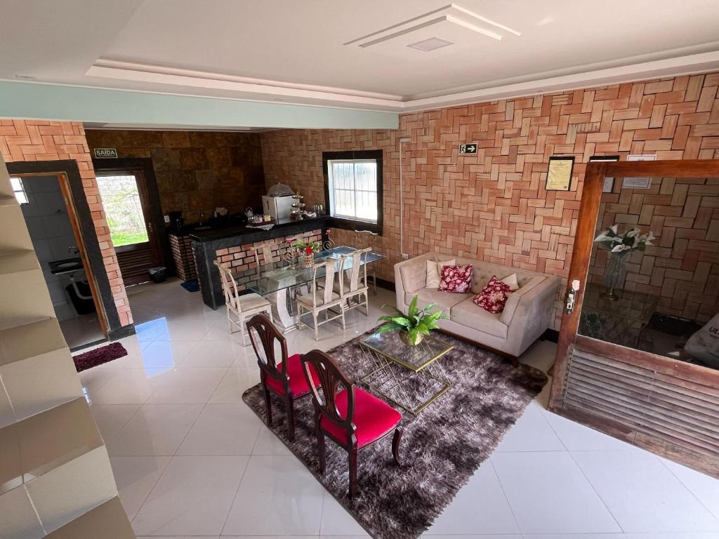 a living room with a couch and a table at Chalé Suíça da Serra in São Benedito