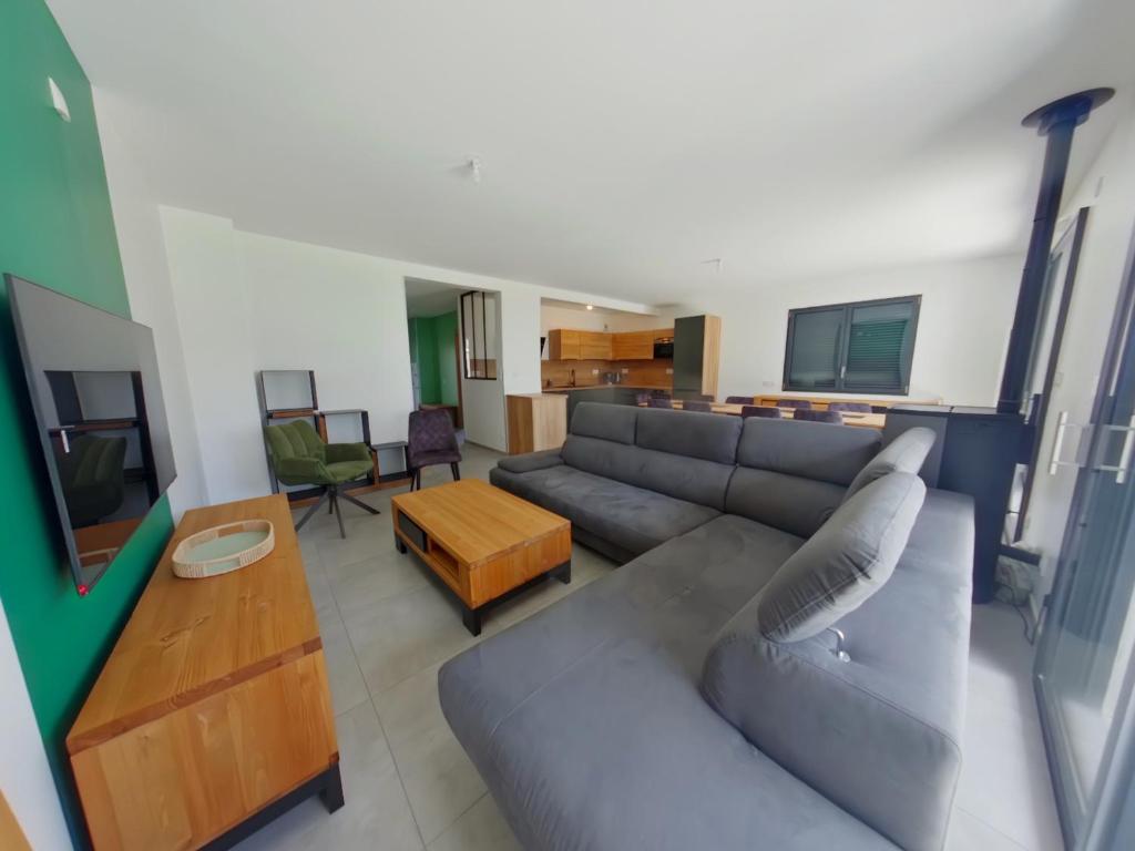a living room with a couch and a table at Villa moderne et spacieuse aux Rousses, proche ski, jusqu'à 12 pers. - FR-1-834-6 in Les Rousses