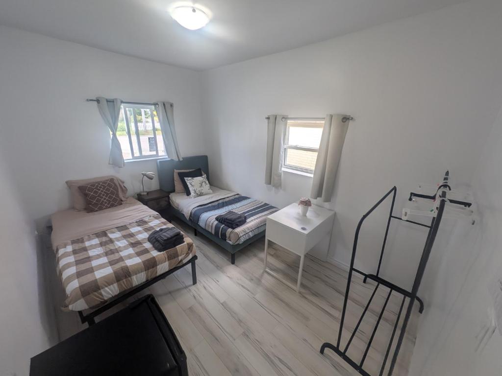 une petite pièce avec un lit et un canapé dans l'établissement 102 Two Single Bed Bedroom Downtown Glace Bay, à Glace Bay