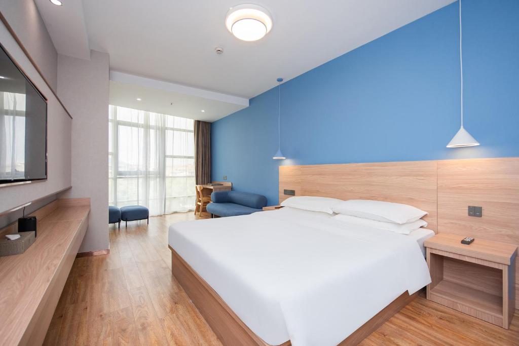 Postel nebo postele na pokoji v ubytování Future Shangju Hotel