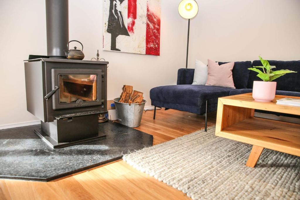 a living room with a fireplace and a couch at Shine Bright in Bright