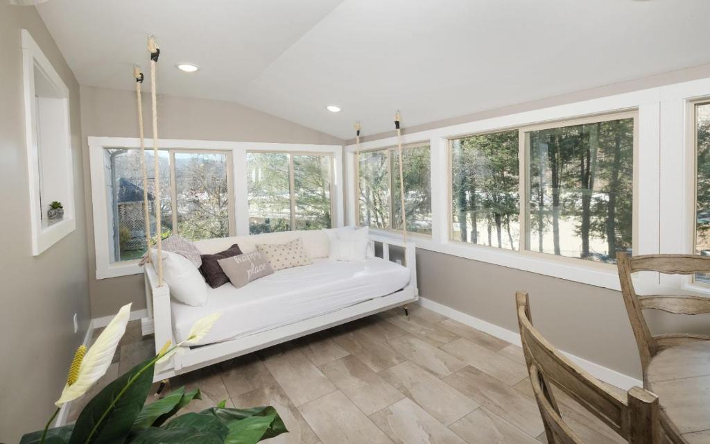 a room with a white couch in front of windows at Ogle Haven in Gatlinburg