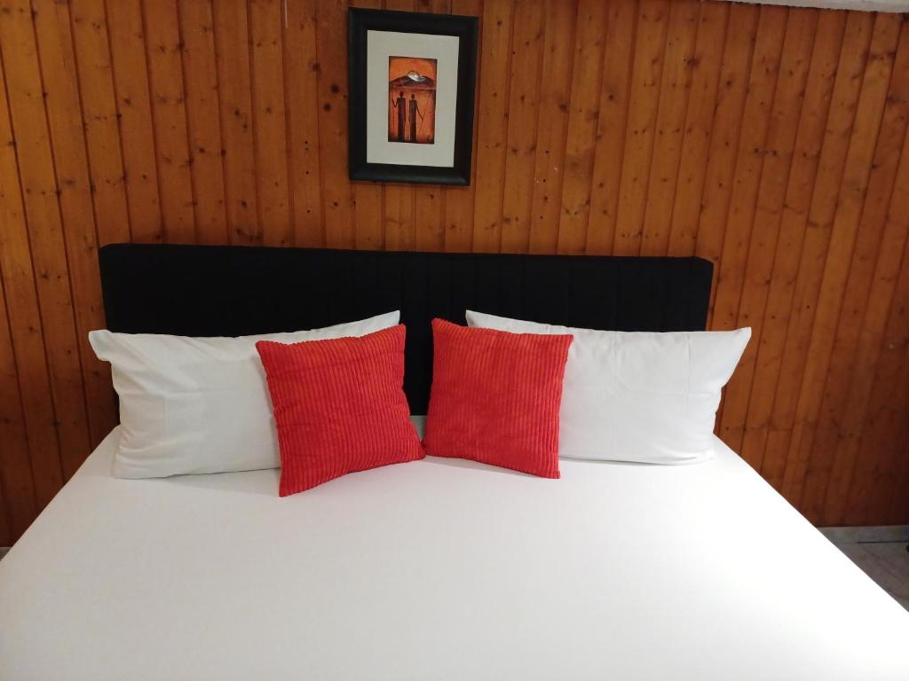 a bed with red and white pillows in a room at Guest house in Datteln 2 & 3 in Datteln