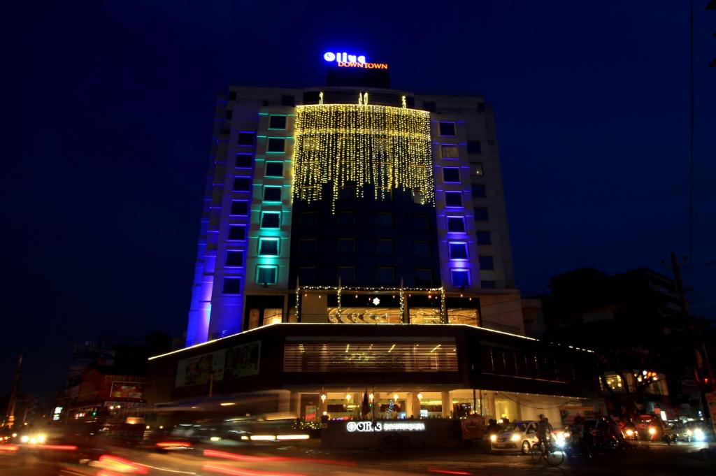 a tall building with blue and green lights on it at Olive Downtown in Cochin