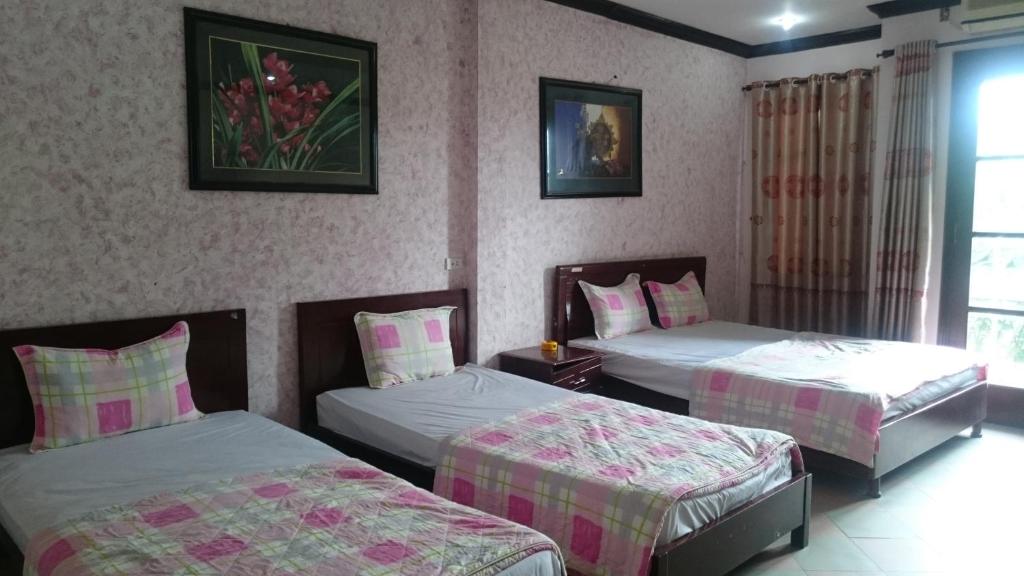 Postel nebo postele na pokoji v ubytování Hai Duong Guesthouse