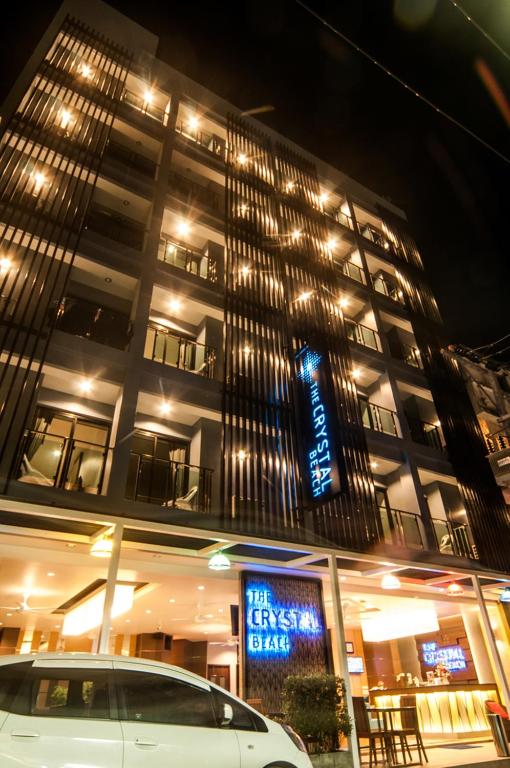 a car parked in front of a building at night at The Crystal Beach Hotel in Patong Beach