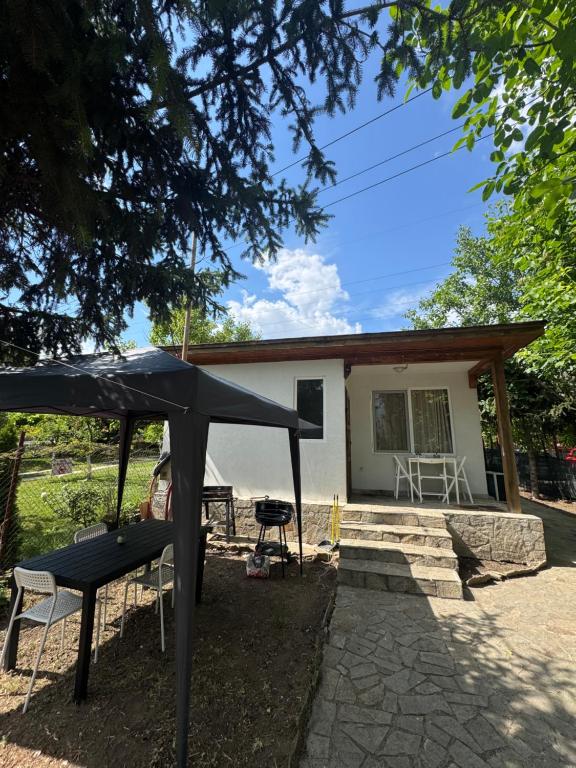 a black tent in front of a house at Cozy House with Free parking in Varna City