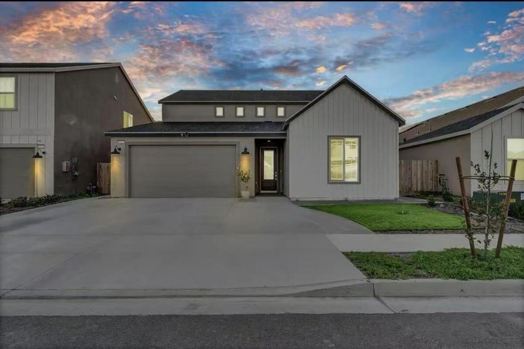 a large house with a garage in a driveway at Joyhouse in Visalia