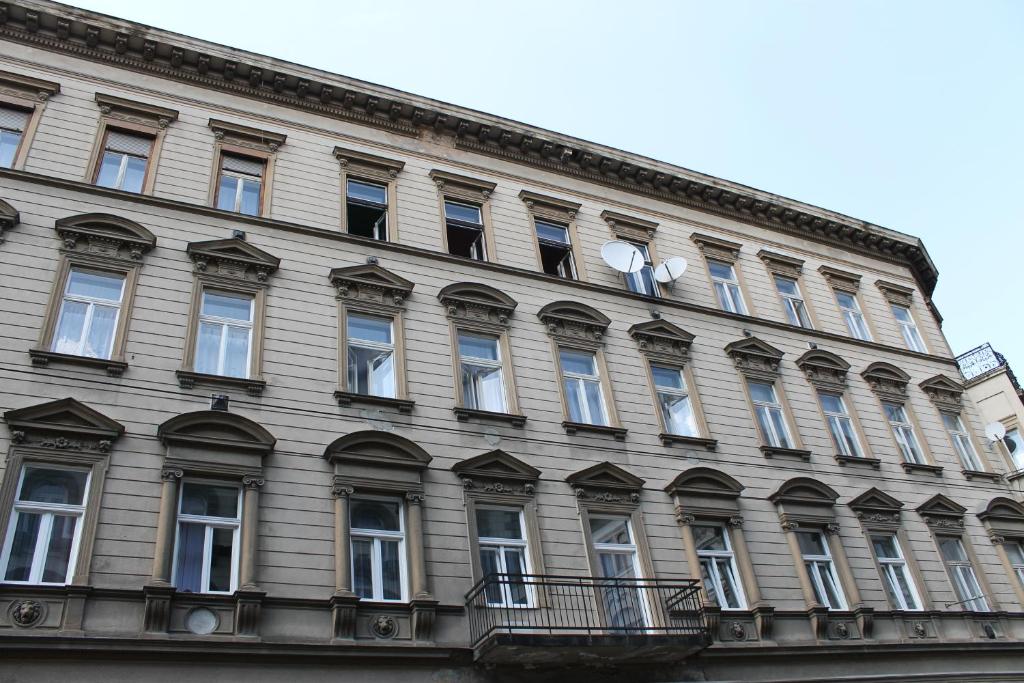 a large building with windows on the side of it at Capital Guesthouse Budapest in Budapest