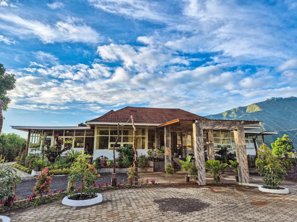 a house with trees and plants in front of it at Asri Rinjani Hotel in Sembalun Lawang