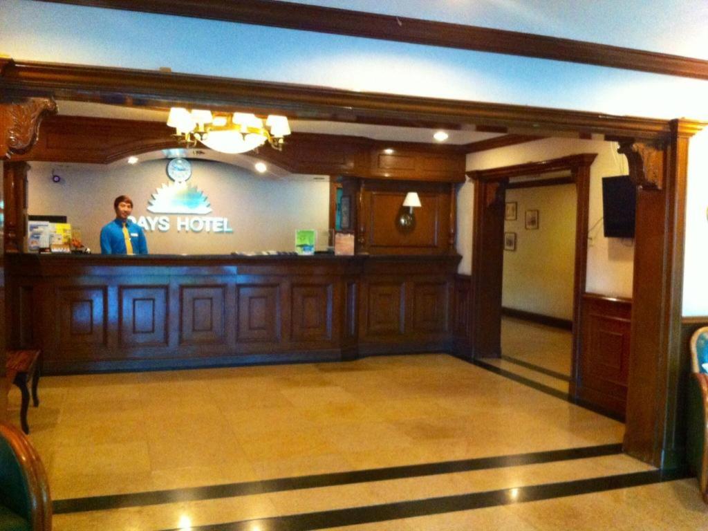 a man standing at the bar of a hotel at Batangas in Dilao