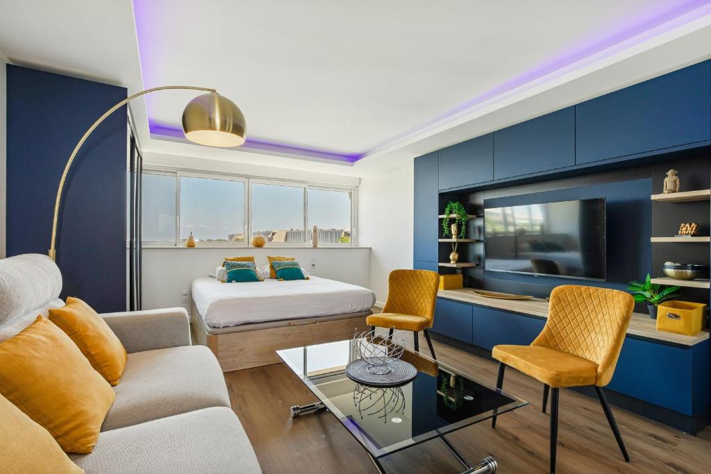 une chambre d'hôtel avec un lit et un salon dans l'établissement l'instant Bleu Port nature, au Cap d'Agde