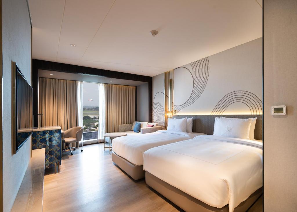 Postel nebo postele na pokoji v ubytování Merlis Hotel Coimbatore