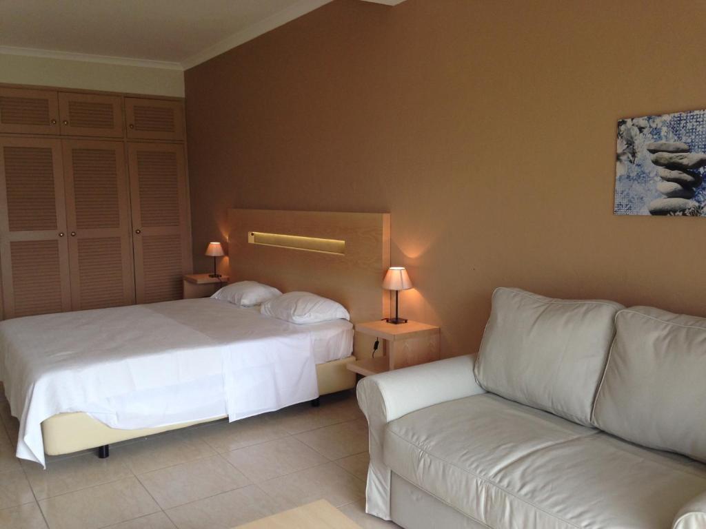 a hotel room with two beds and a couch at Vilamar in Luz