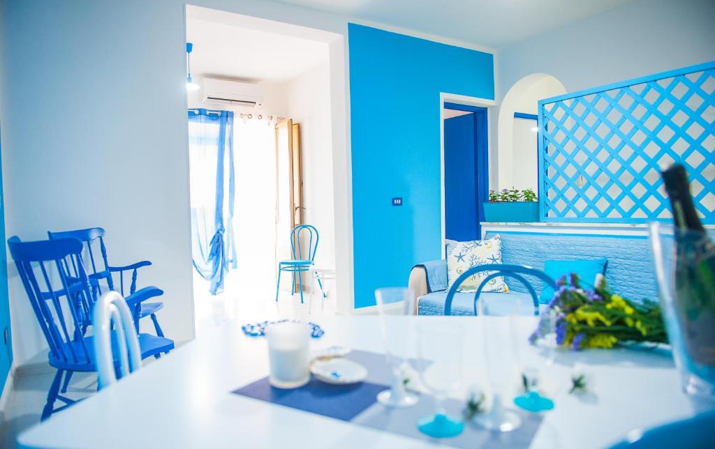 a blue living room with a table and chairs at Blue Suite in Castellammare del Golfo