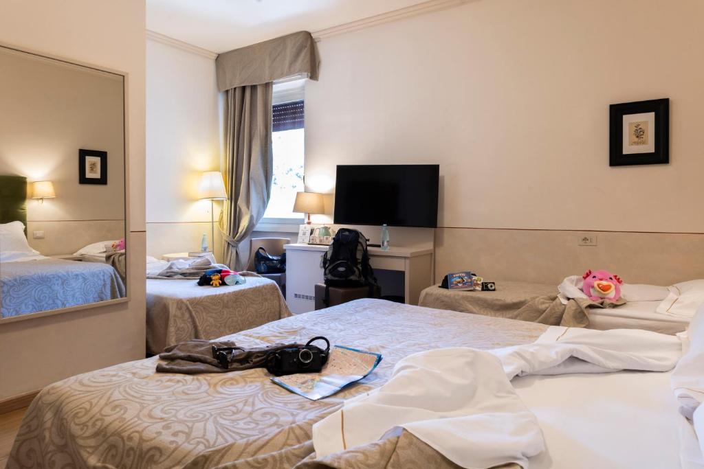 Postel nebo postele na pokoji v ubytování Hotel Ambasciatori