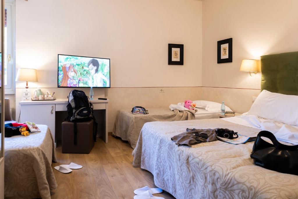 Postel nebo postele na pokoji v ubytování Hotel Ambasciatori