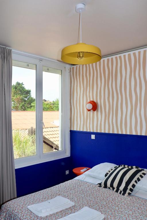 Postel nebo postele na pokoji v ubytování Hôtel Océan