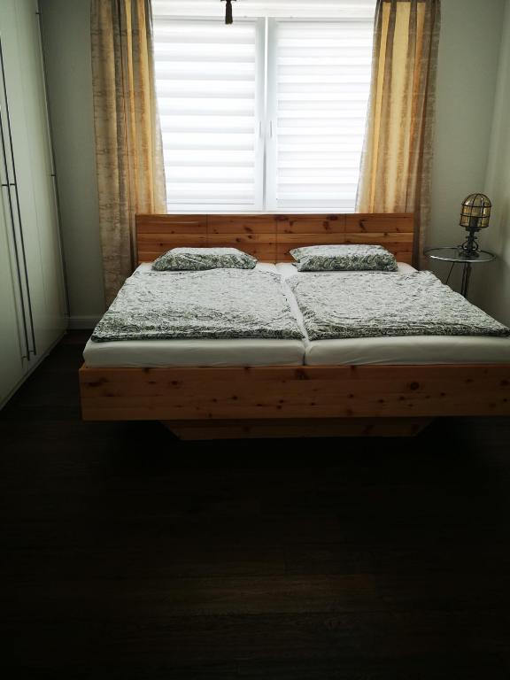 a bed in a bedroom with a large window at Centrally located spacious flat close to Rhine in Bonn