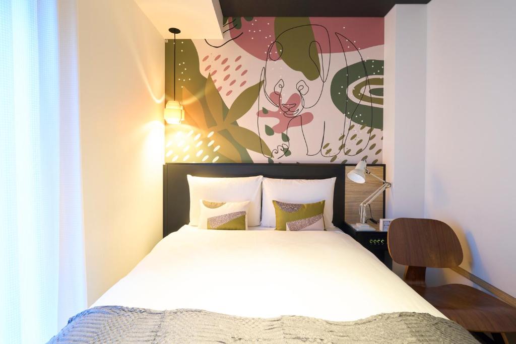 Postel nebo postele na pokoji v ubytování Hotel Resol Ueno