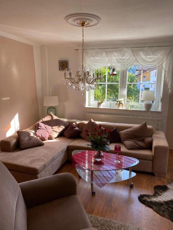 a living room with a couch and a glass table at FeWo Auszeit Andreas Schreiner in Arrach