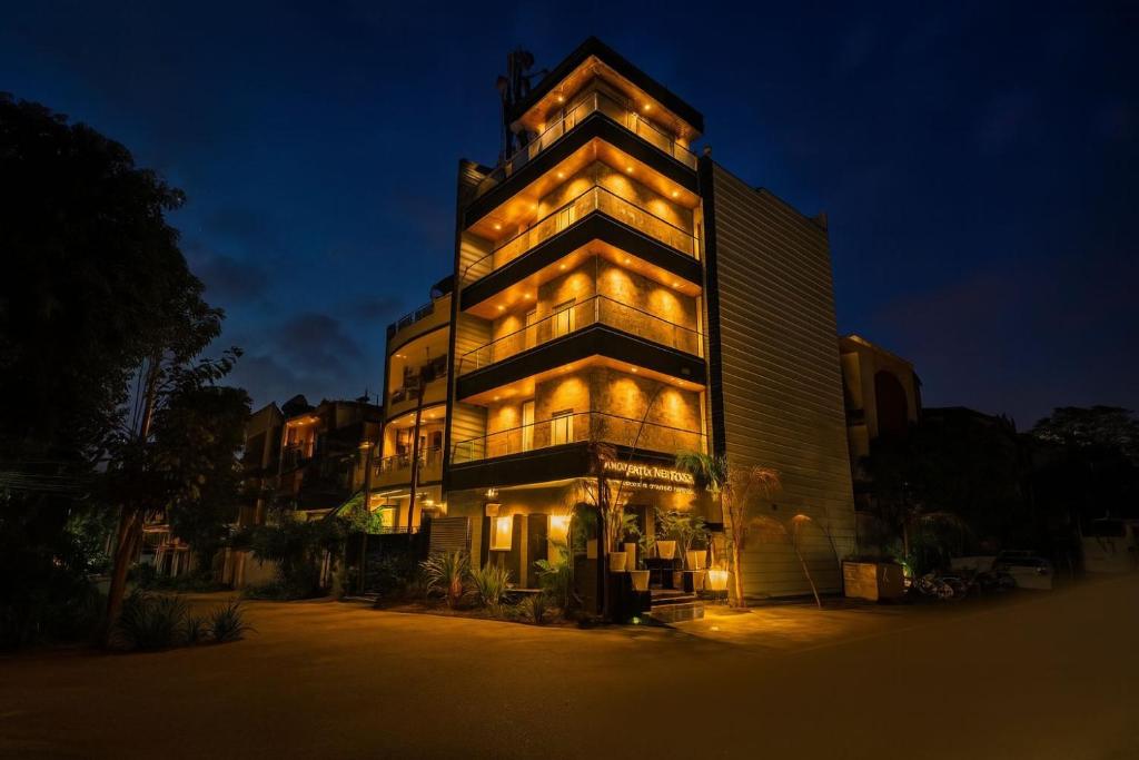 a tall building with lights on it at night at Hotel Downtown, Sector 51 in Noida