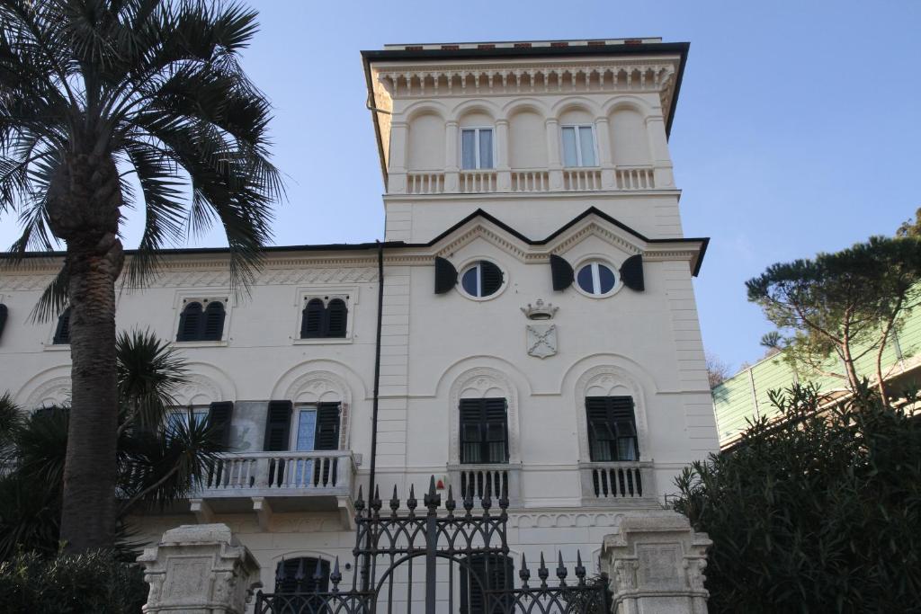 a building with a clock on the side of it at Villa D'Albertis in Crevari