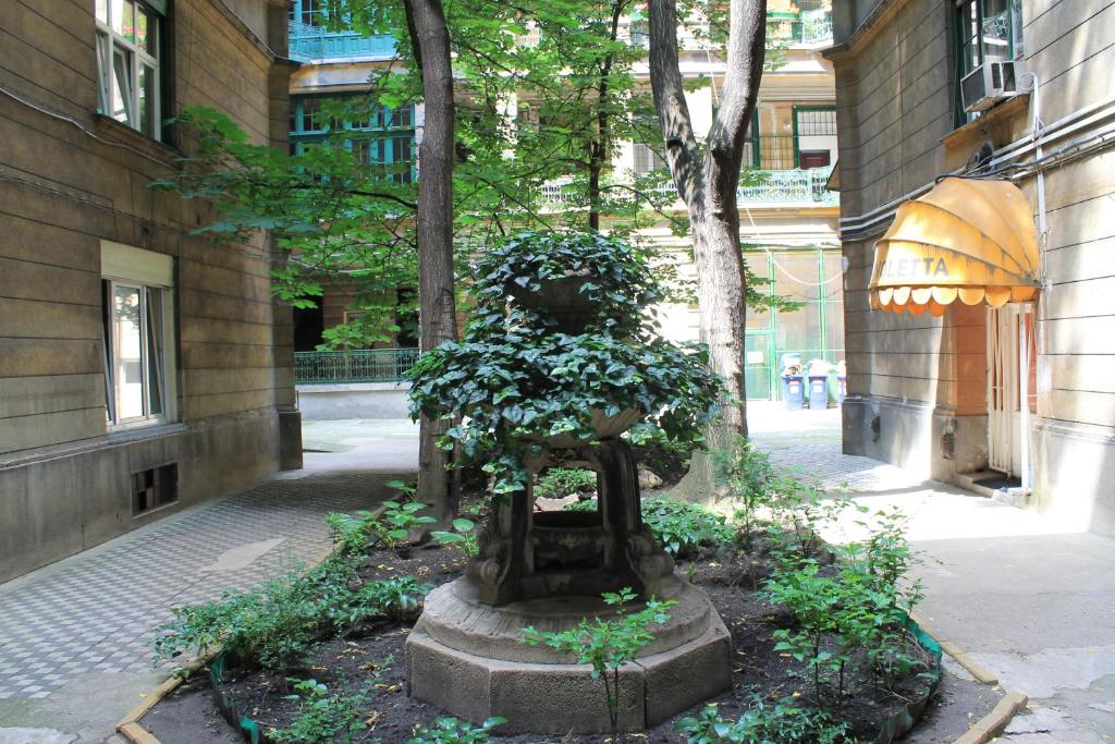 a statue sitting in the middle of a street at Fanni Budapest Guesthouse in Budapest