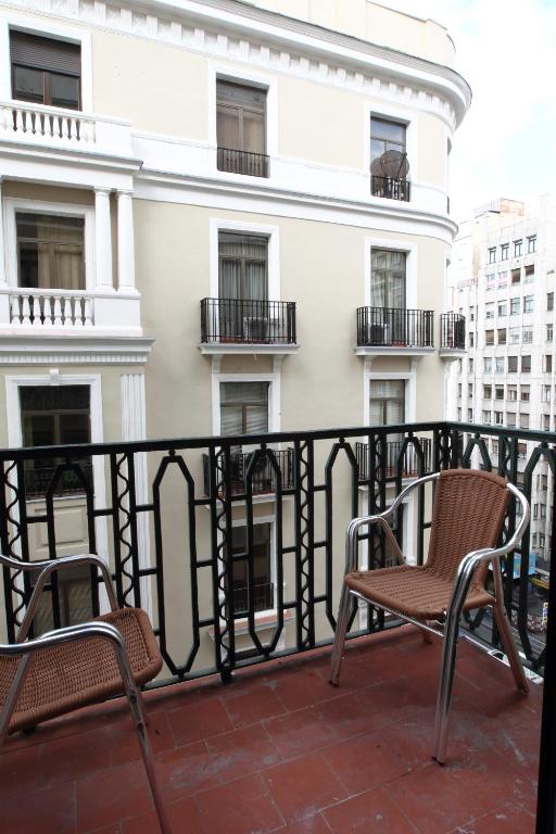 two chairs on the balcony of a building at Rincón de Gran Vía in Madrid