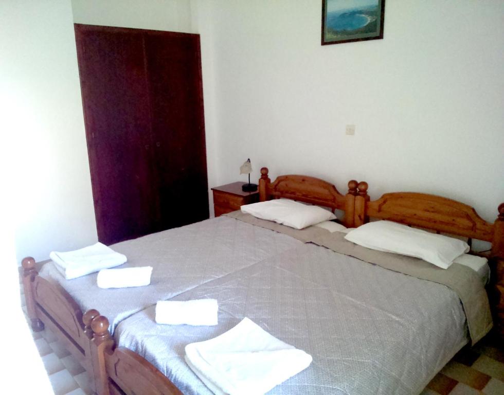 a bedroom with two beds with towels on them at Villa Thomas in Agios Georgios Pagon