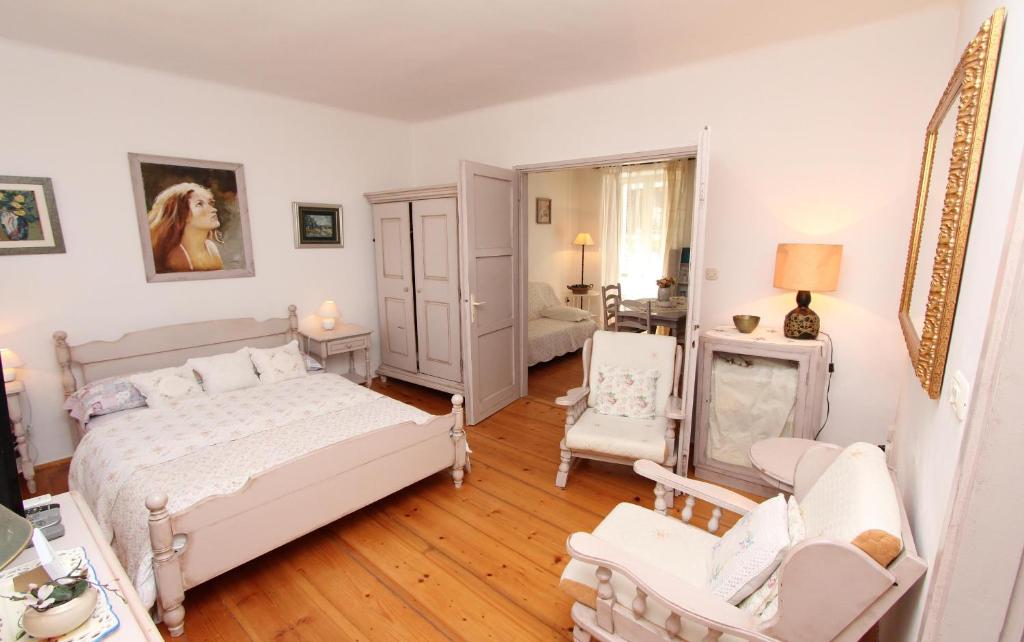 a bedroom with a bed and a living room at Apartments Milkana in Rovinj