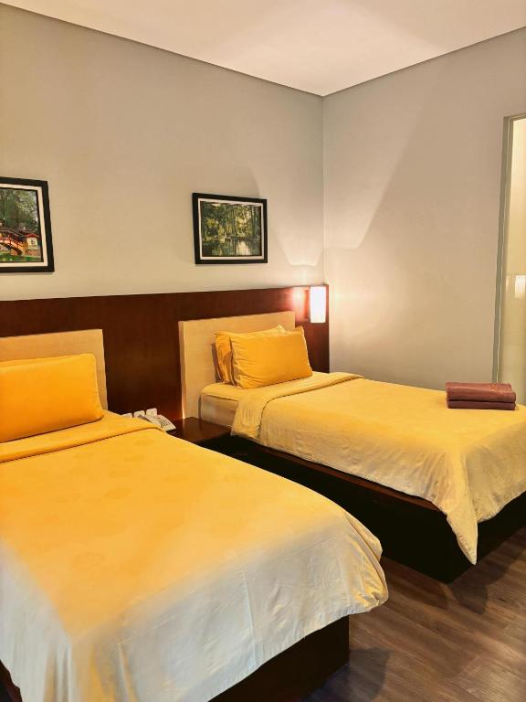 Postel nebo postele na pokoji v ubytování COZY Boutique Guest House