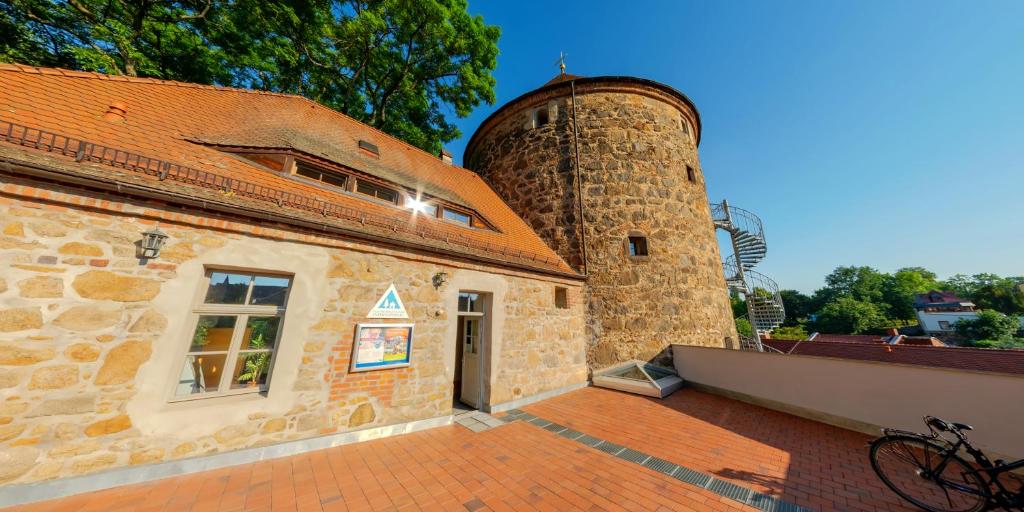 a building with a water tower on top of it at DJH Bautzen Gerberbastei in Bautzen