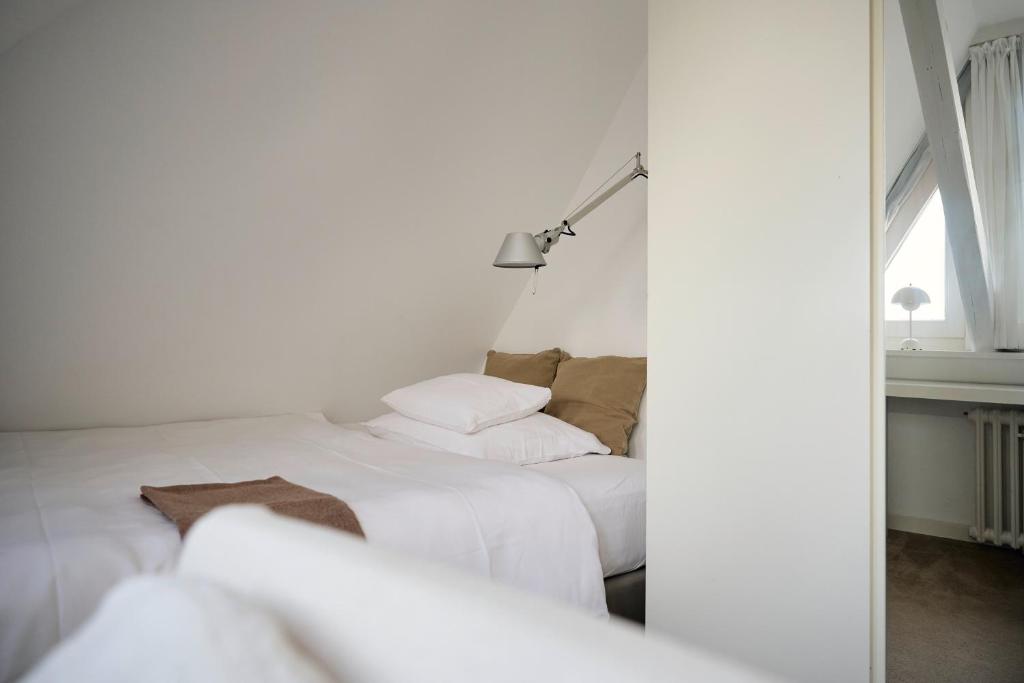 Postel nebo postele na pokoji v ubytování Hotel Haus Norderney