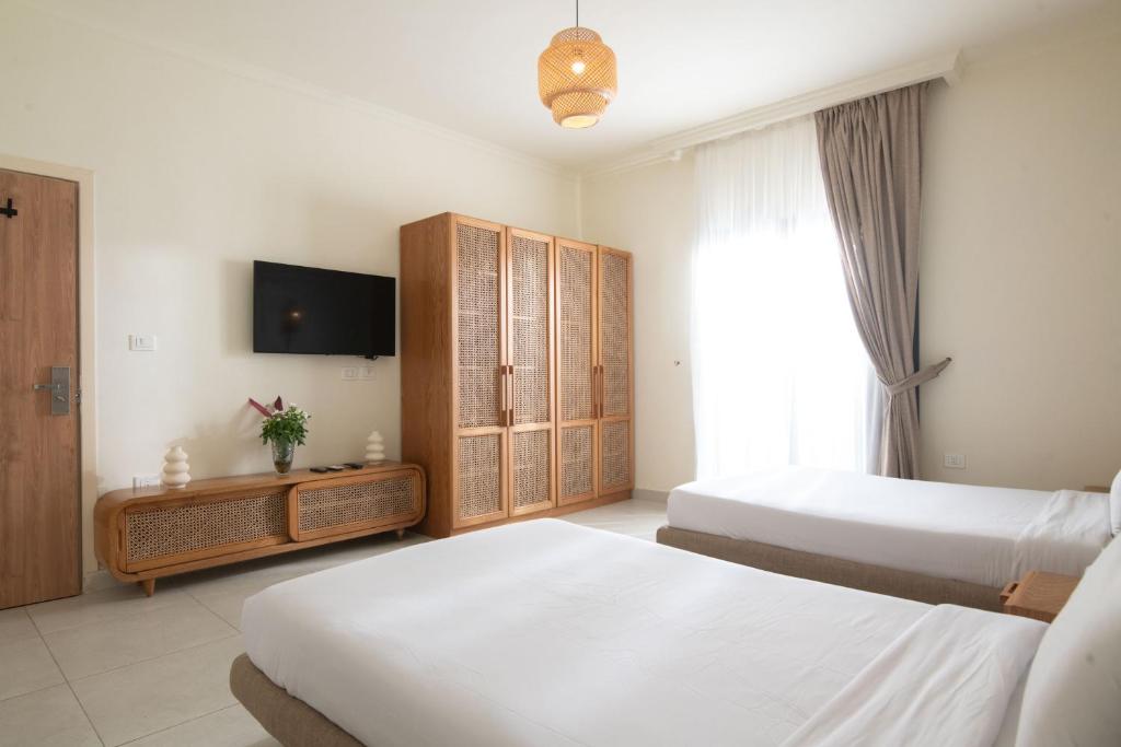 Postel nebo postele na pokoji v ubytování Ios Hotel & Village